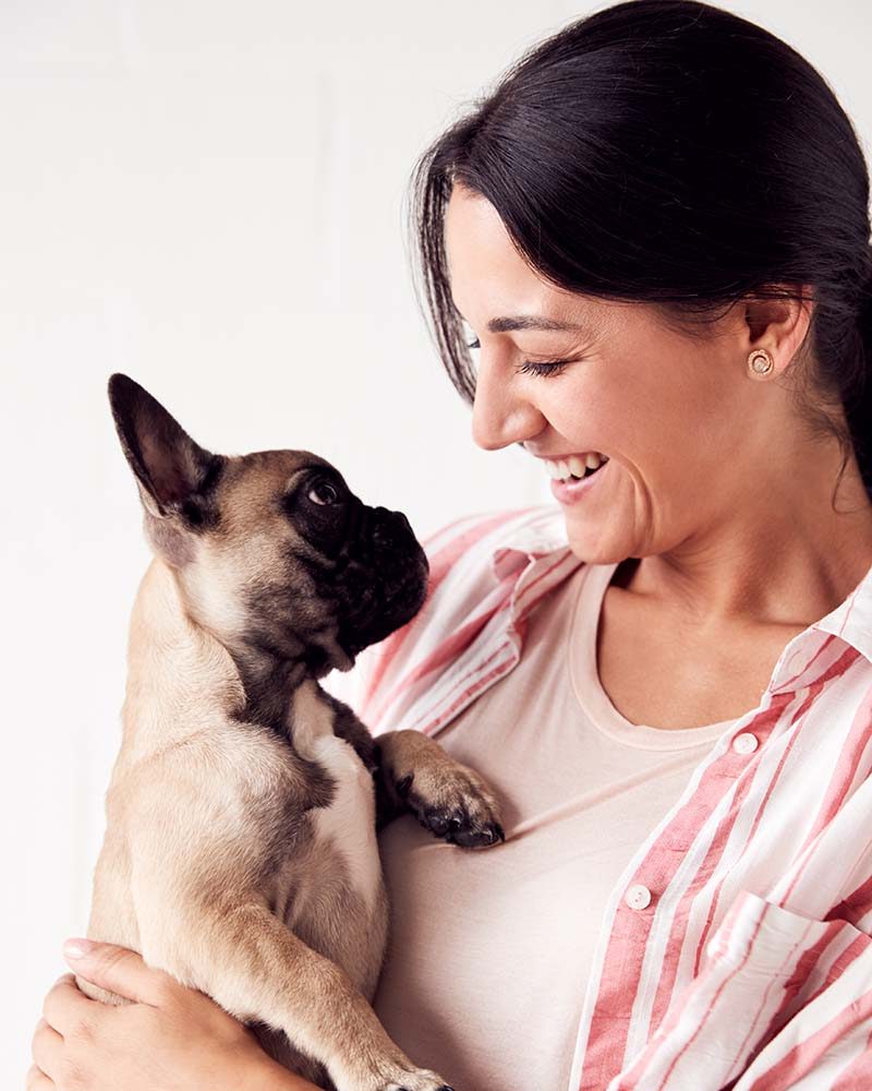 studio-shot-of-smiling-young-woman-holding-affecti-T23C8XB.jpeg